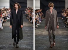 2 male models walking the runway in suits