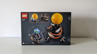 Lego technic planet earth and moon in orbit set on a white background