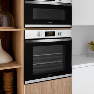 Built-in oven with control knob next to white counter top