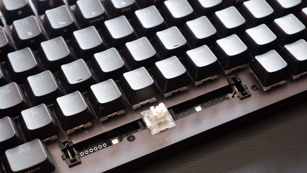 Asus ROG Strix Scope II 96 Wireless gaming keyboard on a desk.
