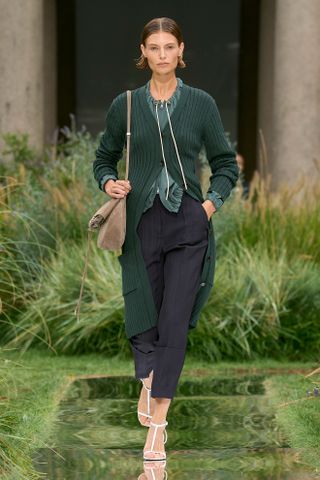 Boss model wearing a cardigan, blouse, and cigarette pants.