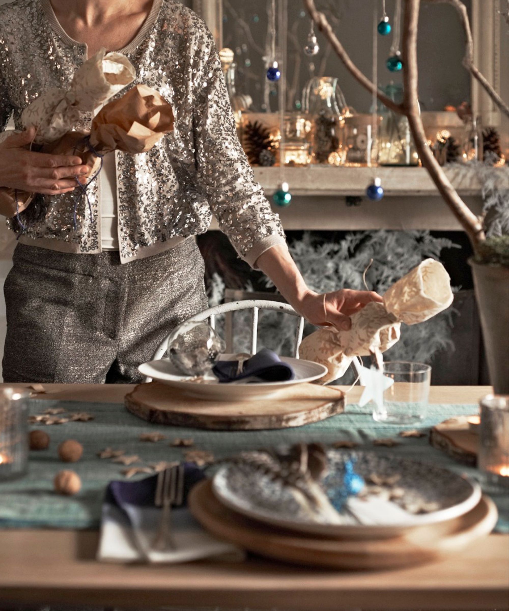 Woman laying a Christmas table