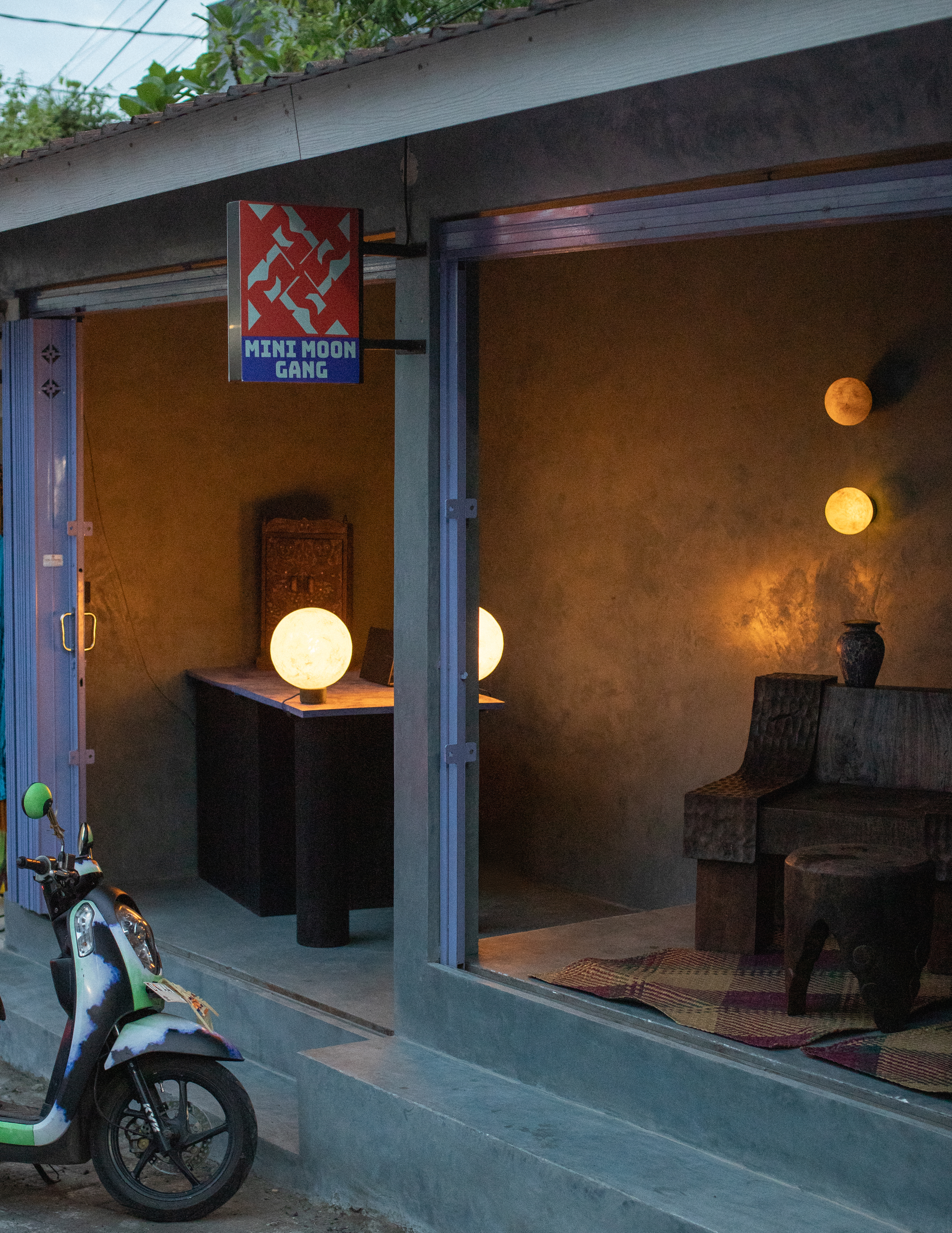 Interiors of a tropical interiors with curved passageways, terracotta walls, colorful curtains, woody furniture, color pops, and nature all around.