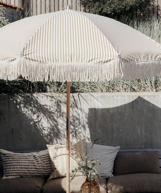 A striped fabric parasol in a garden