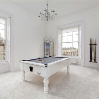 pool room with white wall window childminder and white pool table
