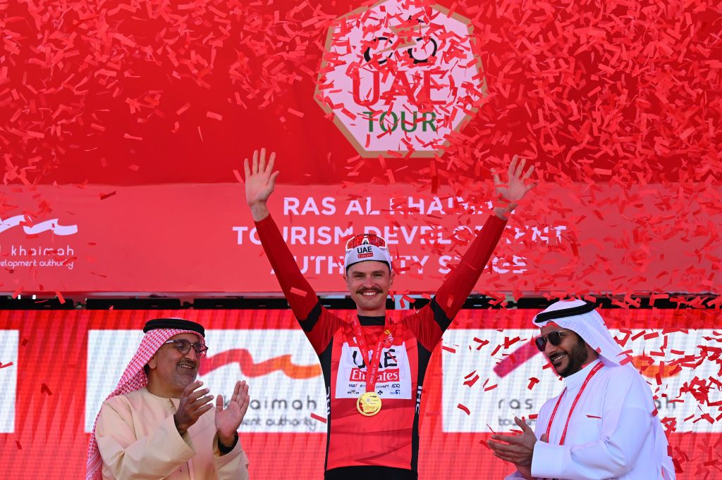 JEBEL JAIS UNITED ARAB EMIRATES FEBRUARY 21 Jay Vine of Australia and Team UAE Emirates celebrates at podium as Red Leader Jersey winner during the 6th UAE Tour 2024 Stage 3 a 176km stage from Al Marjan Island Al Jazirah Al Hamra to Jebel Jais 1489m UCIWT on February 21 2024 in Jebel Jais United Arab Emirates Photo by Tim de WaeleGetty Images