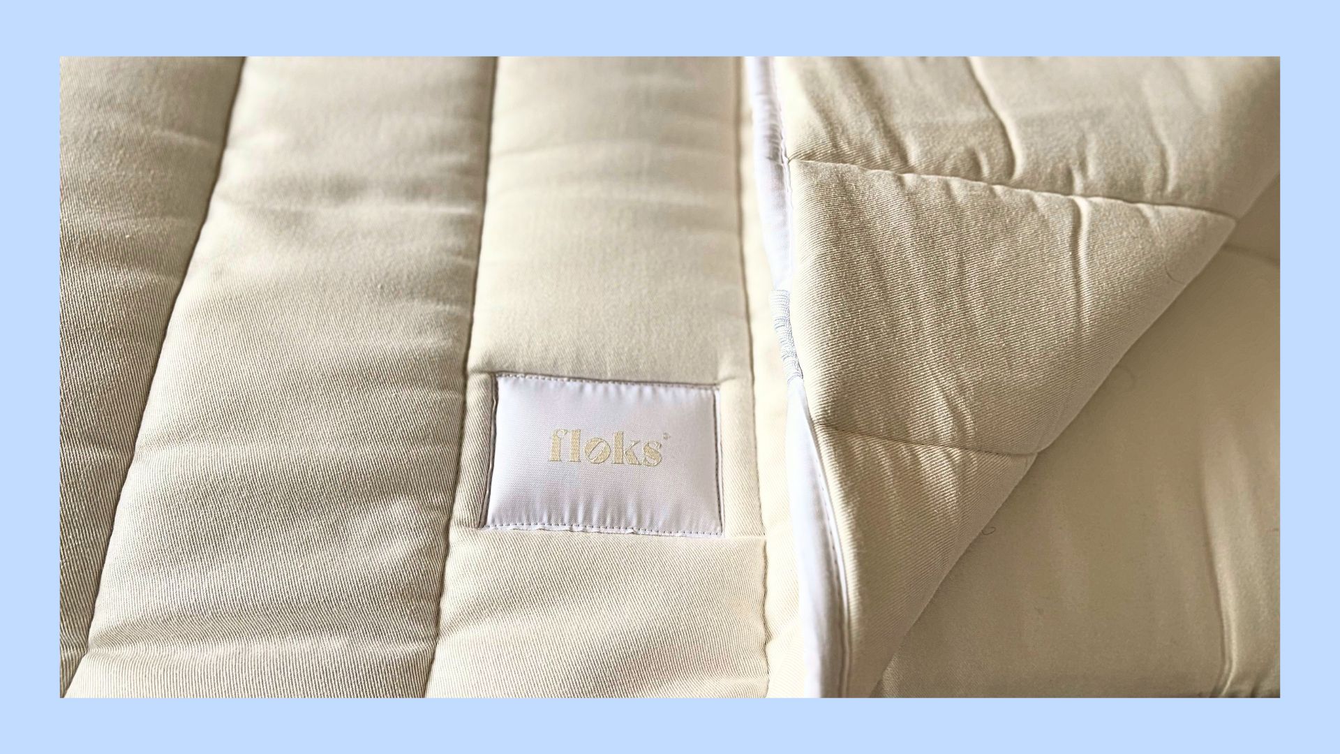 The Floks Mattress topper on a blue background