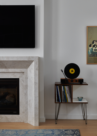 A living room fireplace beside a record player