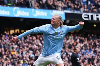 Manchester City striker Erling Haaland celebrates scoring as Manchester United striker Rasmus Hojlund sets new record