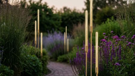 bullrush outdoor lighting in a pretty garden with a path and purple flowers