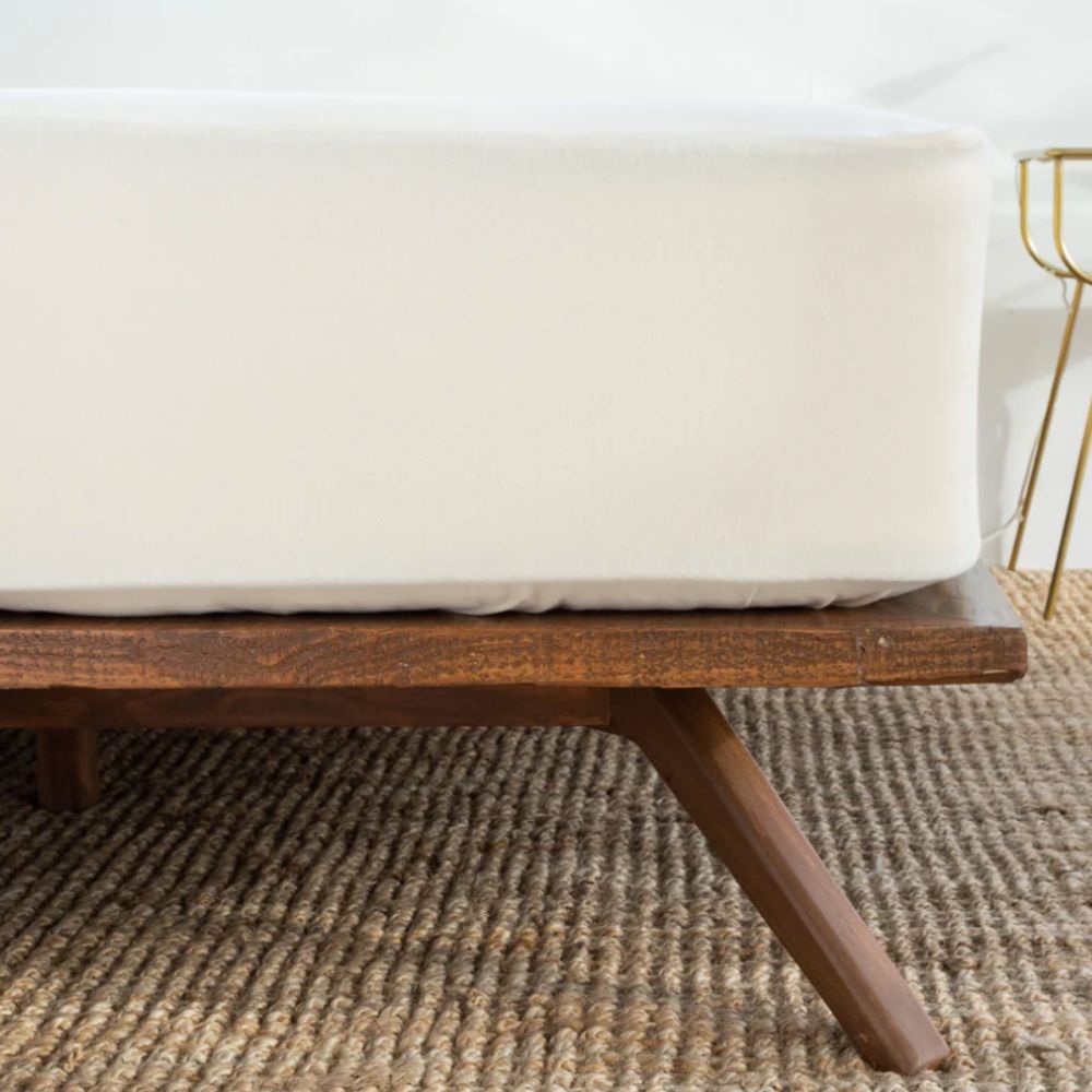 Mattress protector on a wooden bedframe