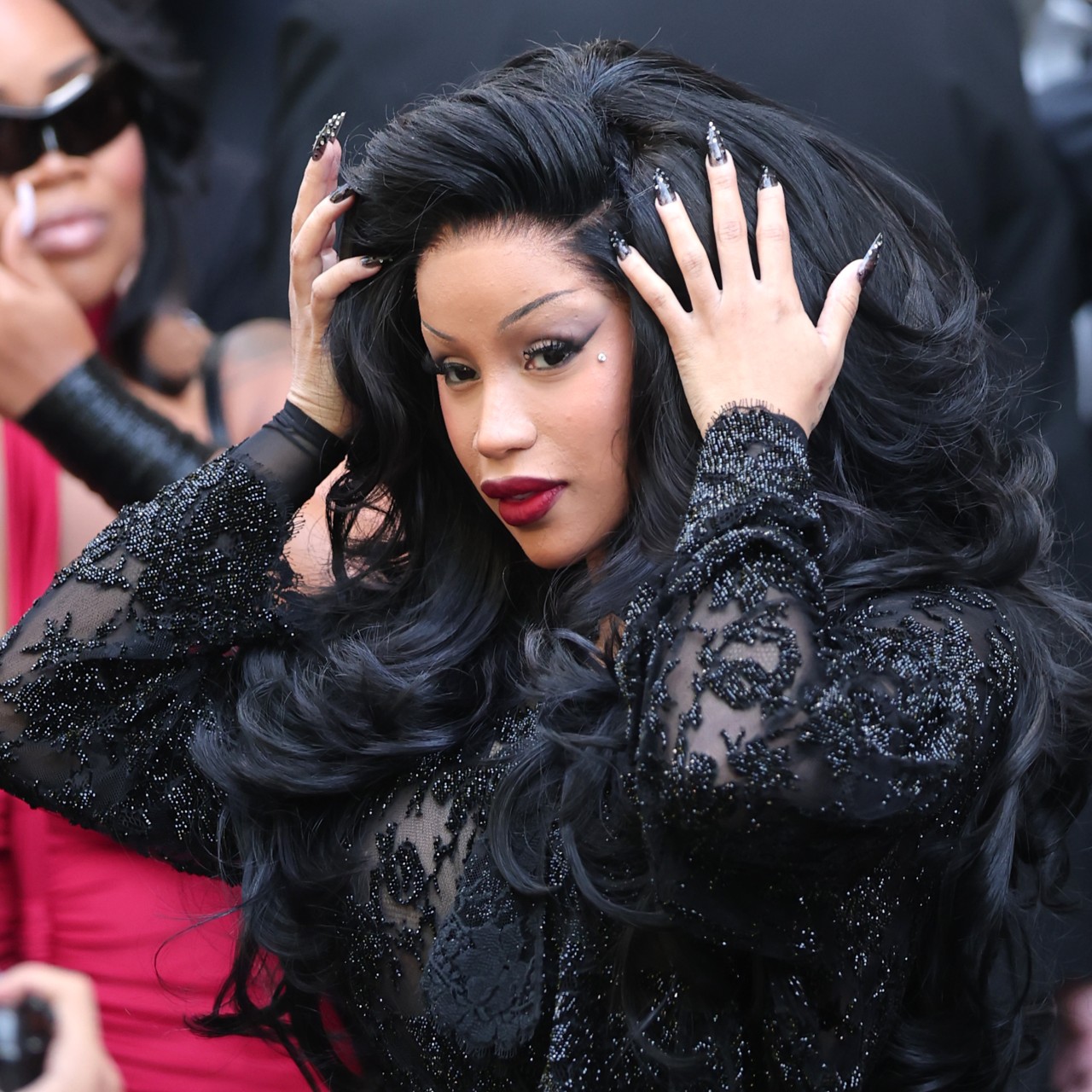 Cardi B wearing a black lace dress