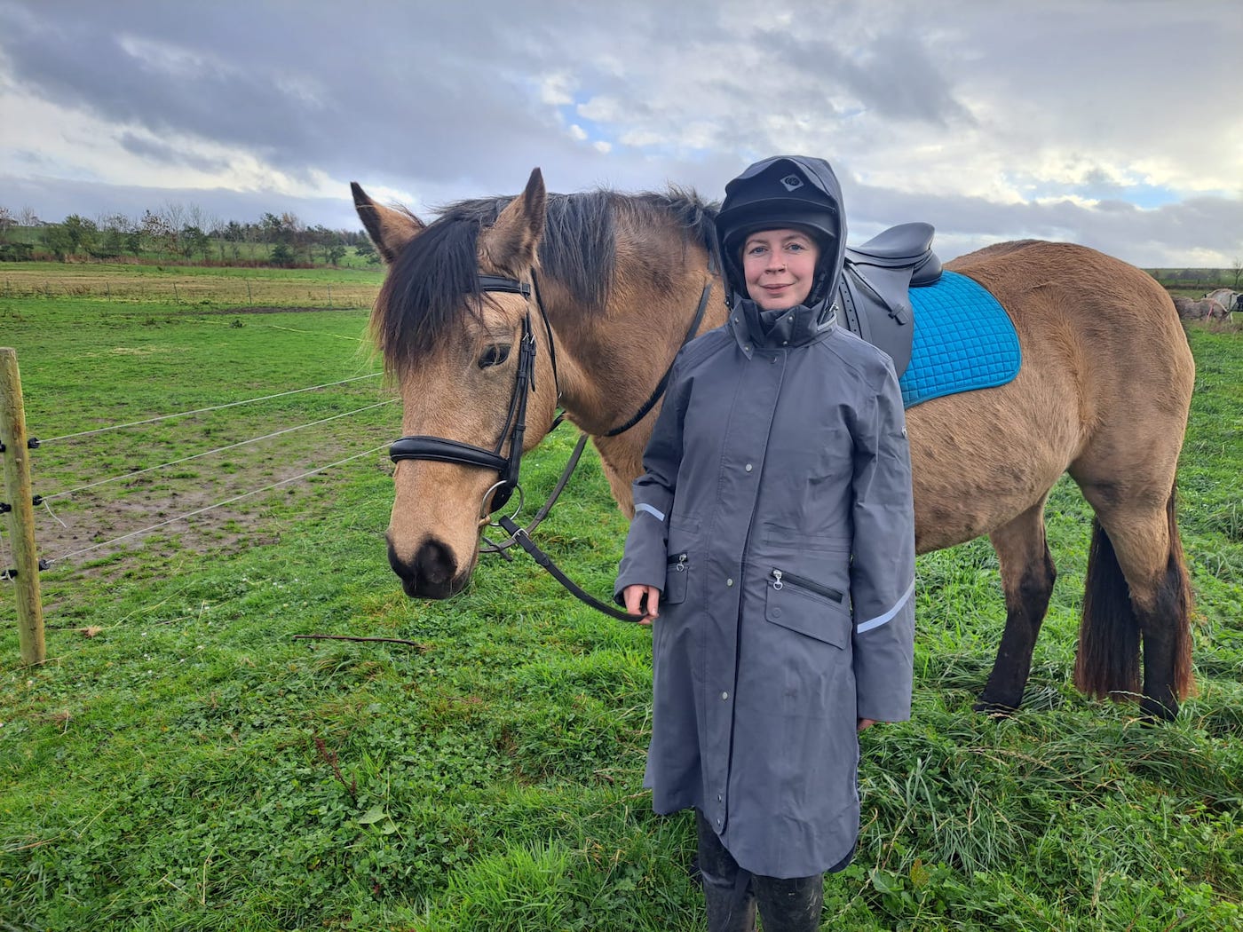 Becky wearing the Equetech Utopia Long Waterproof Riding Coat