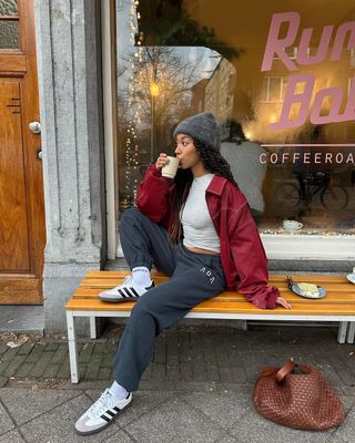 @amaka.hamelijnck wearing sweatpants, t-shirt and red jacket