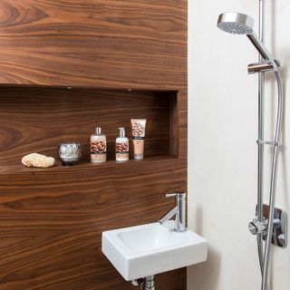 shower area with wooden and tiles wall
