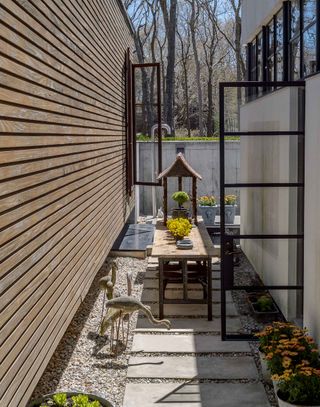 concrete pavers in narrow outdoor space with gravel