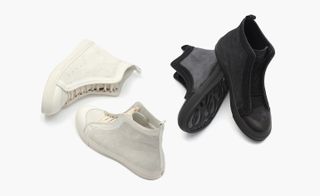 Two pairs of kicks, one black pair and one white pair.