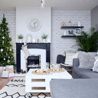 living room with wall watch and christmas tree