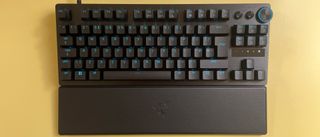 The Razer Huntsman V3 Pro Tenkeyless mechanical gaming keyboard against a yellow background.