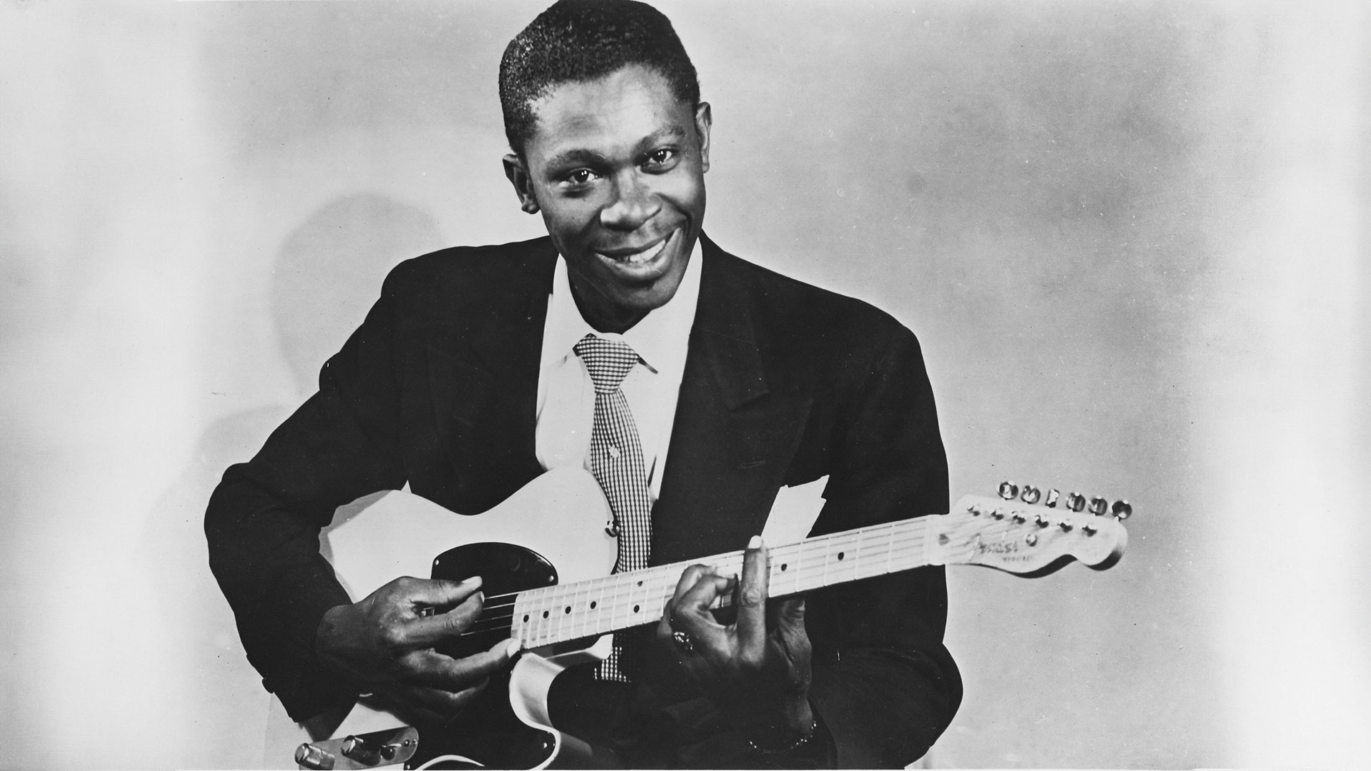 B.B. King poses for a black and white studio portrait in 1955. He holds a Fender Esquire guitar