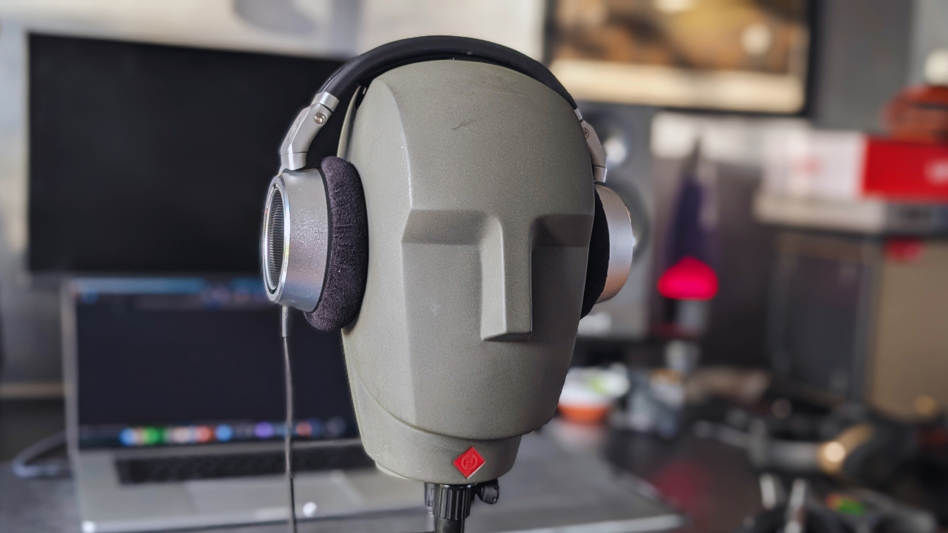 A pair of Neumann NDH 30 headphones on a Neumann KU 100 dummy head