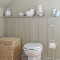 Neutral bathroom with white toilet and flush