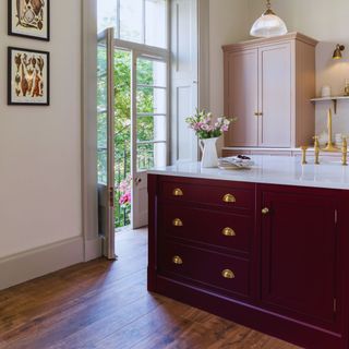 Harvey Jones traditional kitchen with dark red island and light pink cabinetry