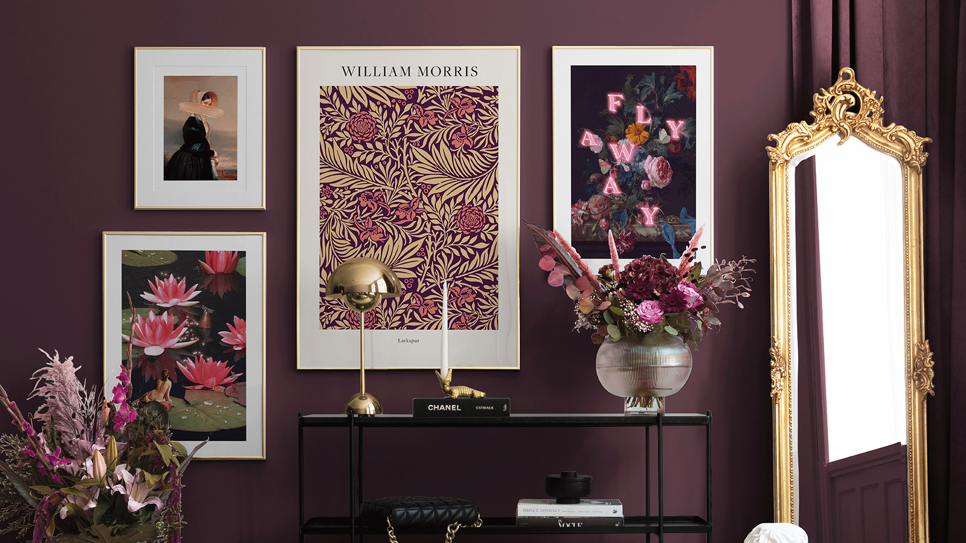 plum wall with five prints and a floral arrangement on a side unit