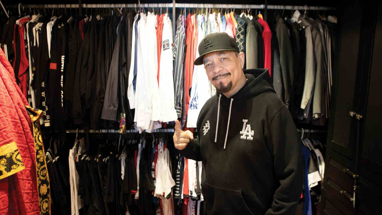 Ice T posing for a photograph at home in a wardrobe of clothes