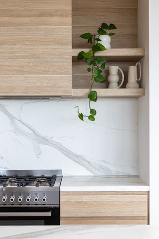 A small kitchen with a marble backsplash