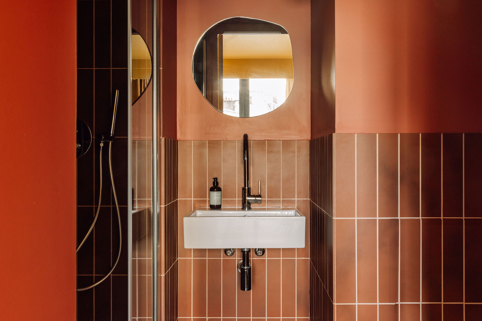 A brightly decorated, patterns and plush textiles-filled hotel's rooms and common spaces feature an earthy palette ranging from ochre and green to terracotta, orange, and brown.