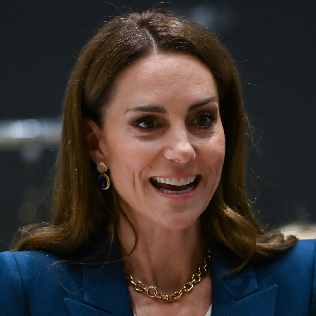 Princess Kate wearing a blue suit and laughing