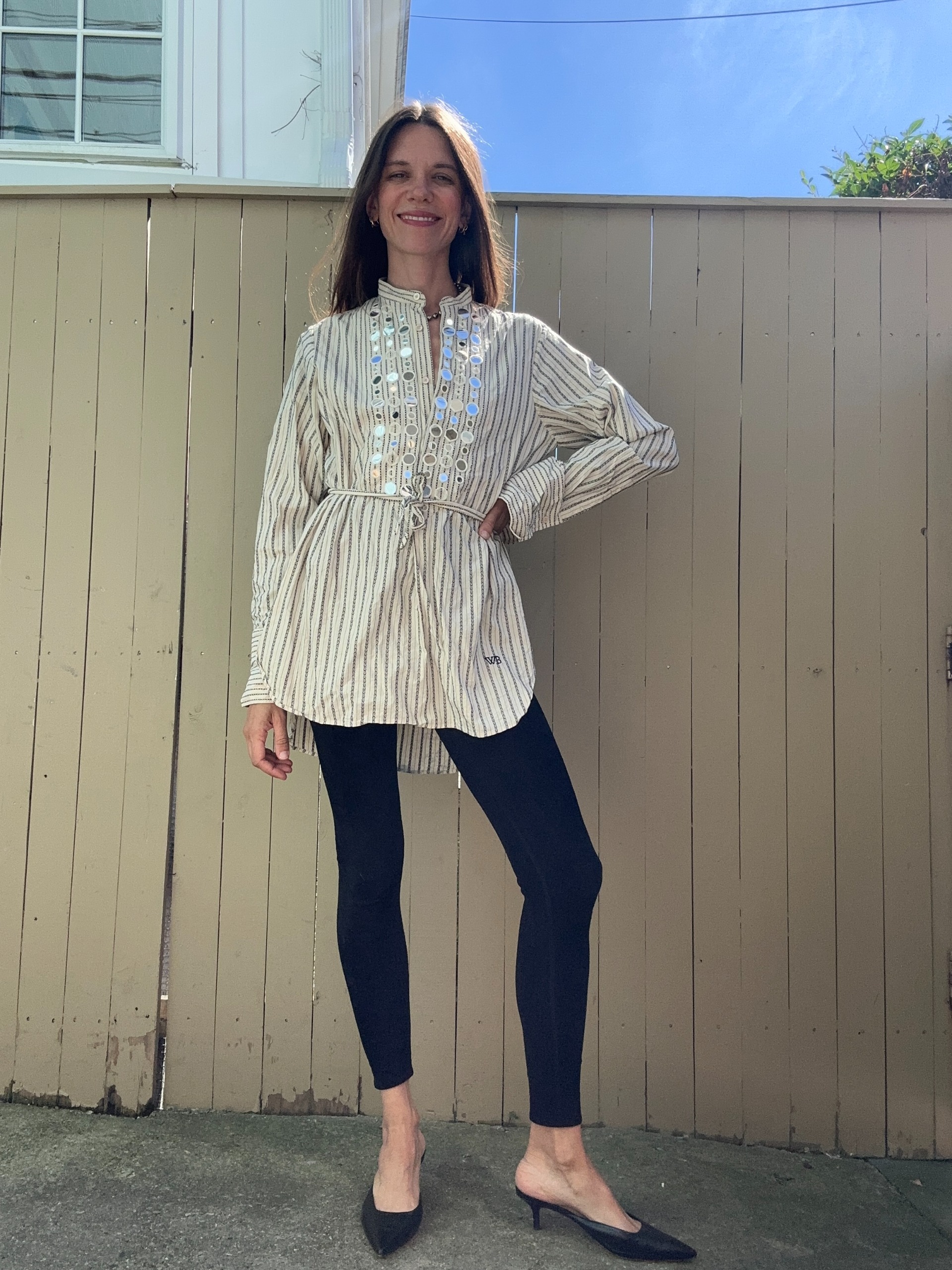 Julia Gall styles an elaborate tunic with black leggings and kitten-heeled mules