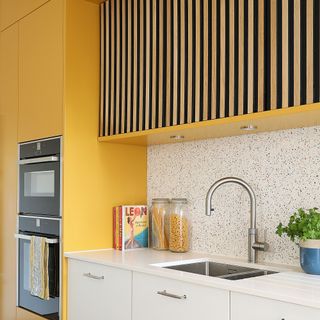 Yellow kitchen with white kitchen sink