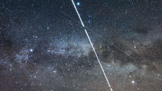 The International Space Station – the bright streak – shoots across the Milky Way amid the Summer Triangle stars on May 29, 2017 during one of its several passes this night Other fainter satellite trails are also visible Vega is at top, Deneb at left, Altair at right — the three stars of the Summer Triangle