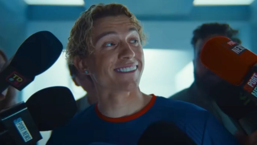 Tom Holland smiling with blonde hair in his Lego ad. 