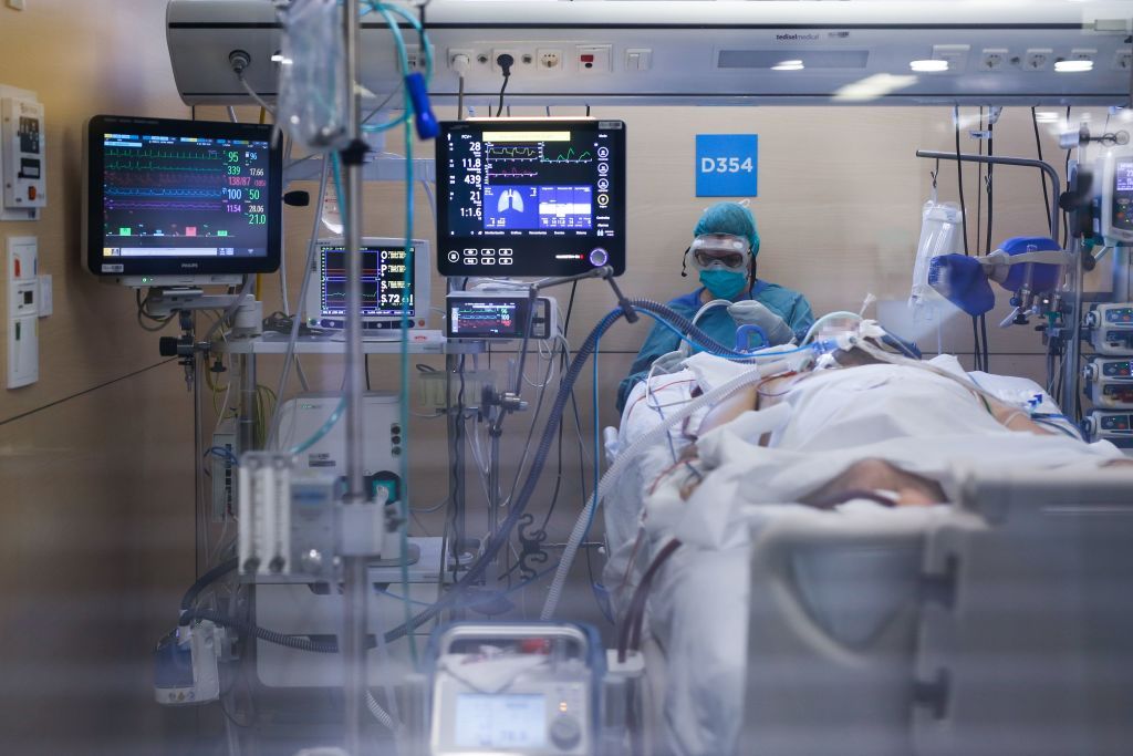 A healthcare worker wearing a protective suit attends to a COVID-19 coronavirus patient at the Intensive Unit Care (ICU) of the Vall d&amp;#039;Hebron Hospital in Barcelona on April 6, 2020.