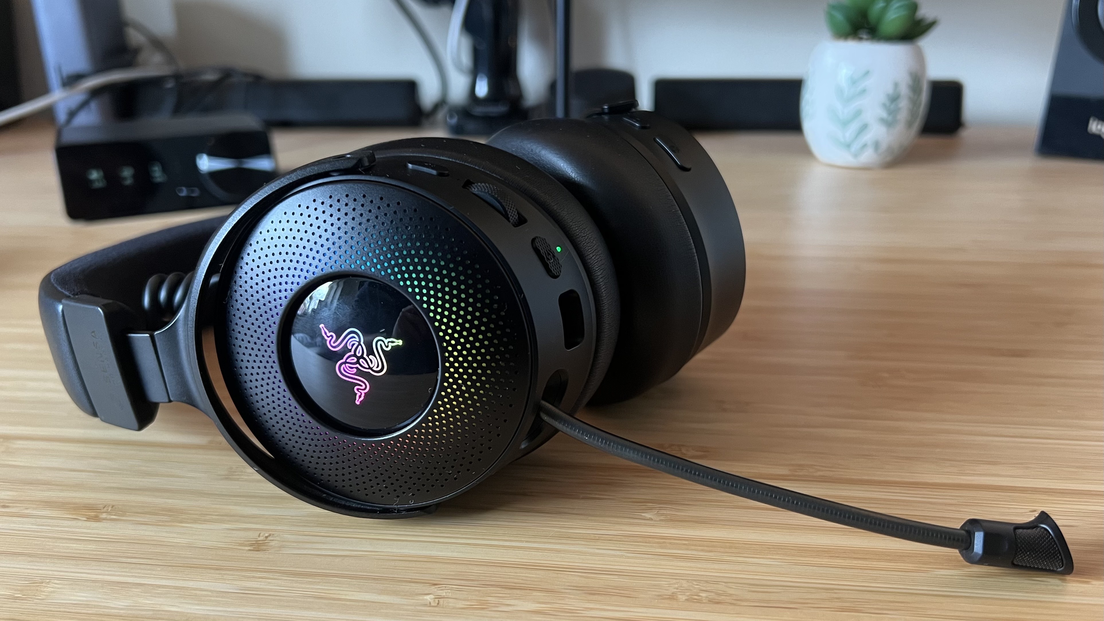 Razer Kraken V4 Pro headset on a desk with microphone extended