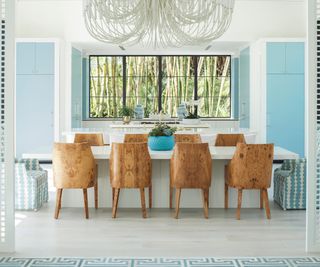 Dining room with blue walls and brown chairs