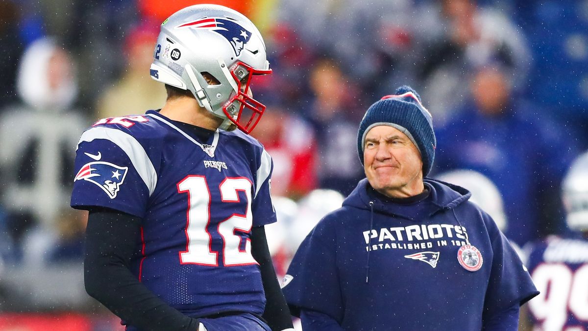 Tom Brady #12 talks to head coach Bill Belichick of the New England Patriots before an NFL game