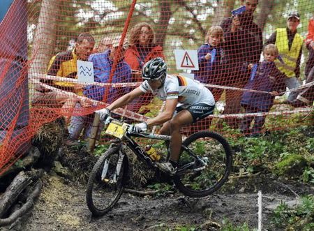 Sabine Spitz en route to victory in a muddy women's race.