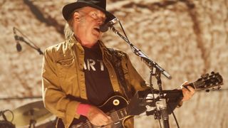 Neil Young sings and plays guitar at Farm Aid in Chicago