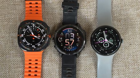 The Samsung Galaxy Watch Ultra (left), Garmin Fenix 8 (middle), and Google Pixel Watch 3 (right) sitting on a chair.