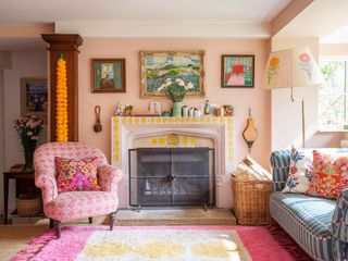 Pink living room with painted fireplace and artwork