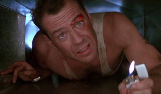 Die Hard Bruce Willis crawls through the ventilation shaft with a lighter