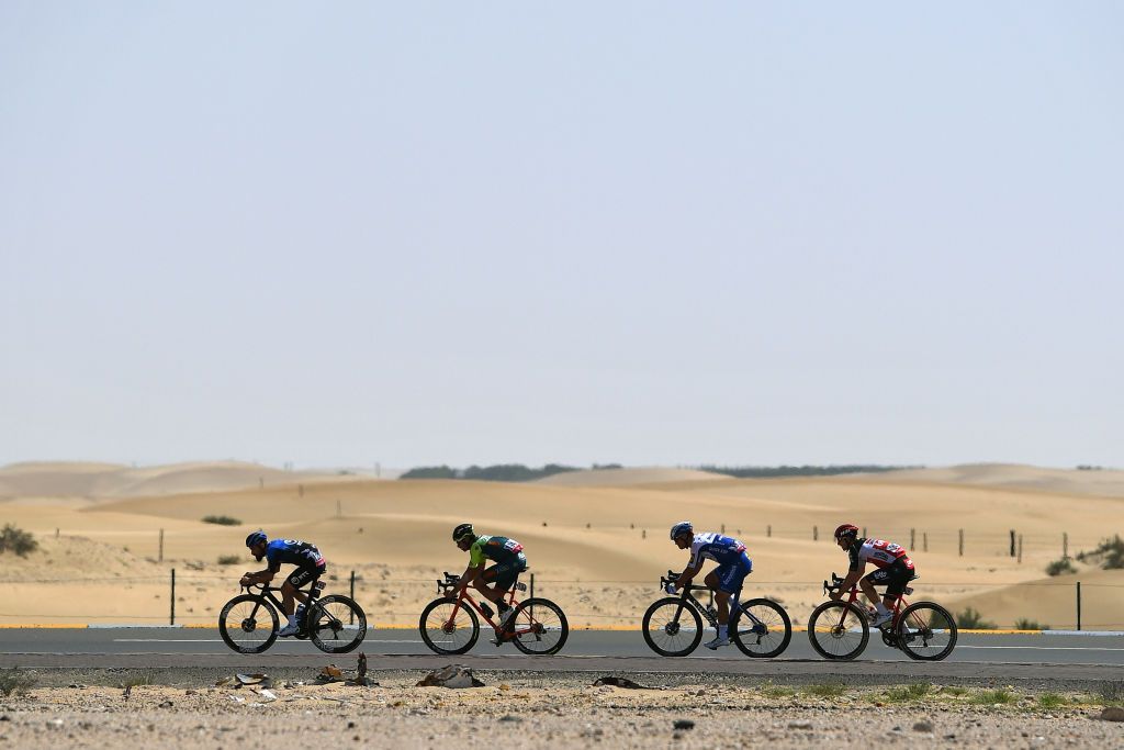 The four riders in the break race across the desert
