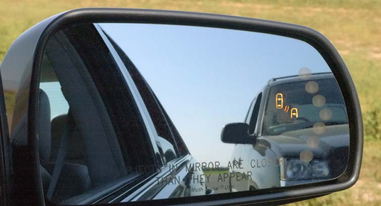 The Cadillac STS side mirror warns drivers of dangers lurking in blind spots before they change lanes.