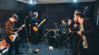 Band practicing together in a studio