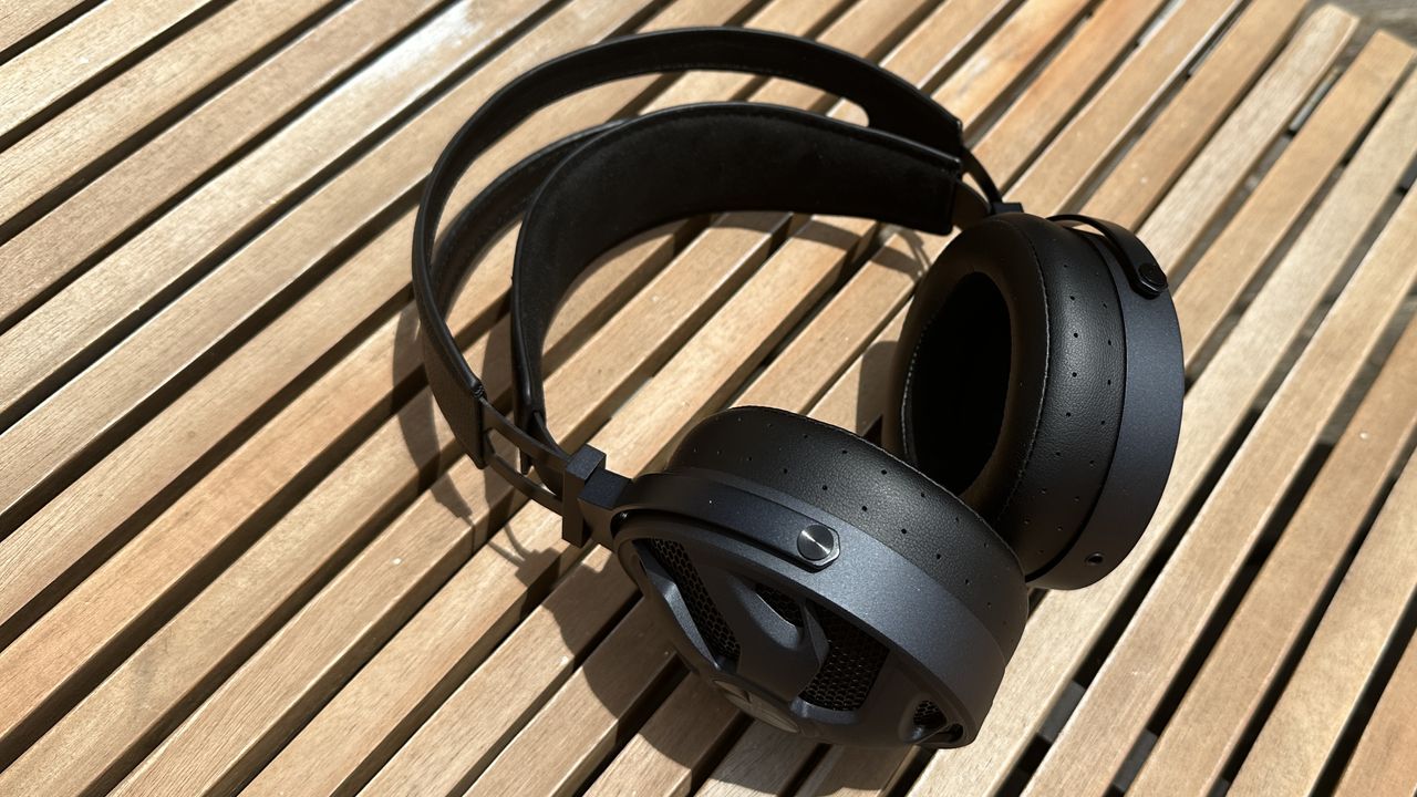 The FiiO FT3 headphones on a wooden surface.