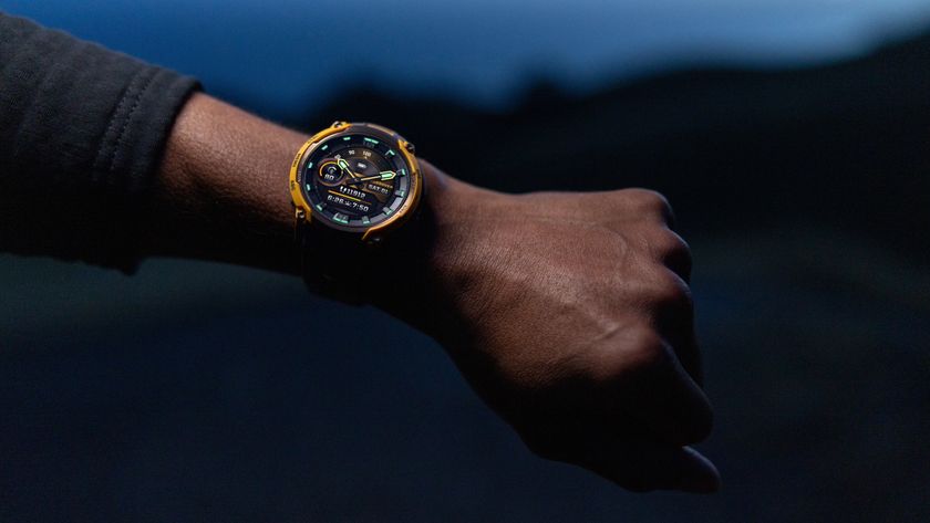 A photo of the Garmin Instinct Crossover AMOLED watch on a person&#039;s arm at night.